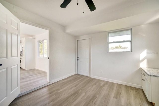 interior space with ceiling fan and light wood-type flooring