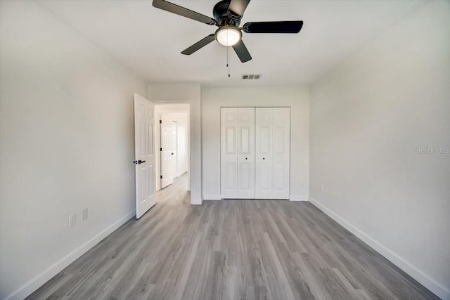 unfurnished bedroom with a closet, ceiling fan, and light hardwood / wood-style flooring