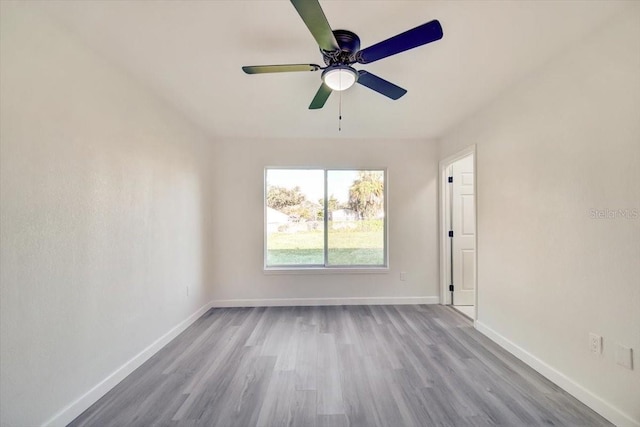 spare room with ceiling fan and light wood-type flooring