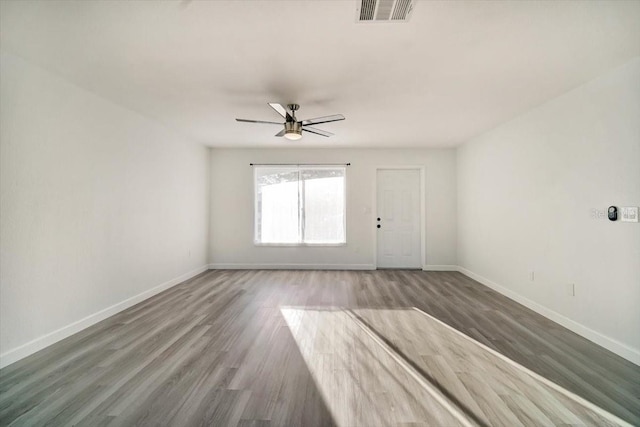 spare room featuring dark hardwood / wood-style flooring and ceiling fan