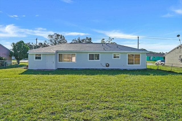 back of house with a lawn