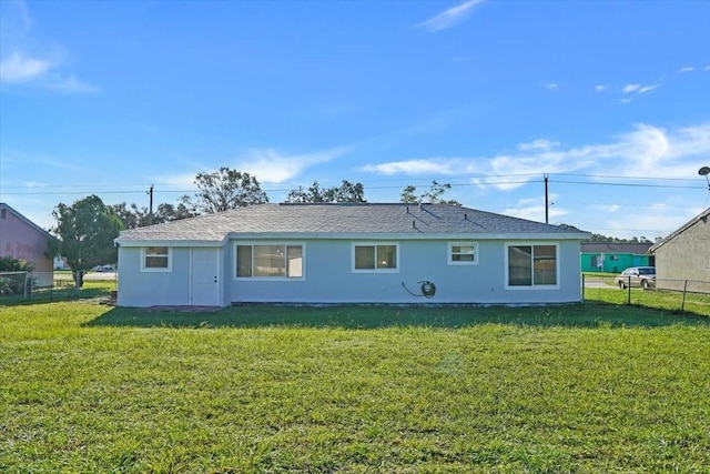 rear view of house with a yard