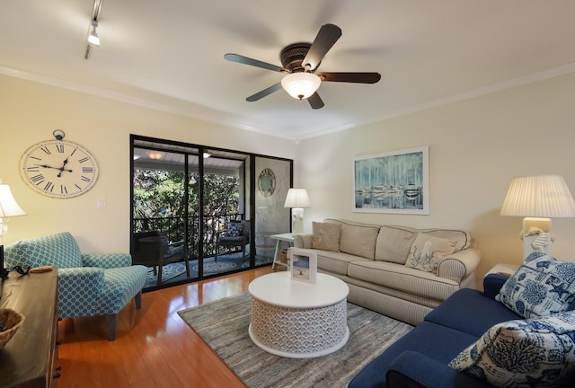 living room with hardwood / wood-style floors, crown molding, and ceiling fan