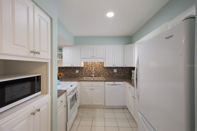 kitchen featuring white appliances, sink, light tile floors, tasteful backsplash, and white cabinetry