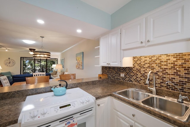 kitchen with a notable chandelier, white electric stove, white cabinets, crown molding, and pendant lighting