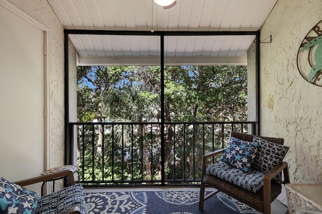 unfurnished sunroom with vaulted ceiling with beams