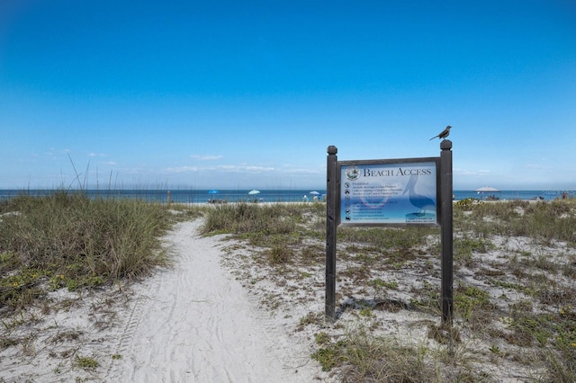 community / neighborhood sign with a water view