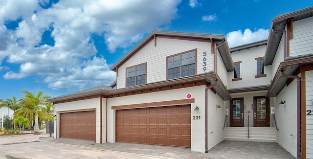 view of front of property with french doors and a garage