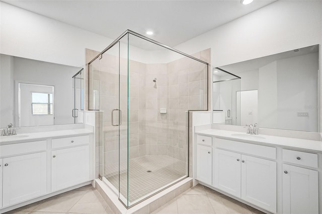 bathroom with tile patterned flooring, vanity, and walk in shower