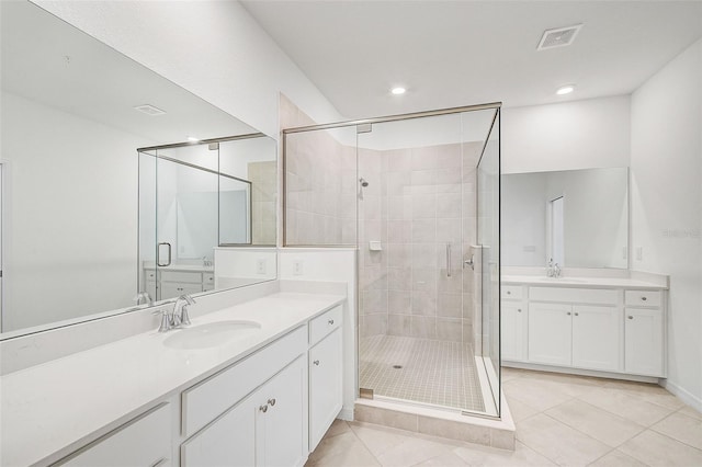 bathroom with tile patterned floors, vanity, and walk in shower