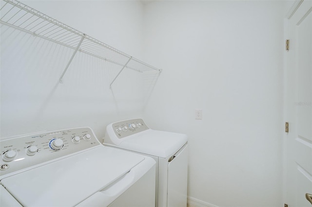 laundry area featuring washing machine and clothes dryer