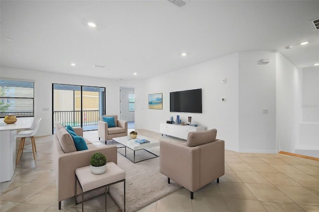 living room featuring plenty of natural light and light tile patterned floors