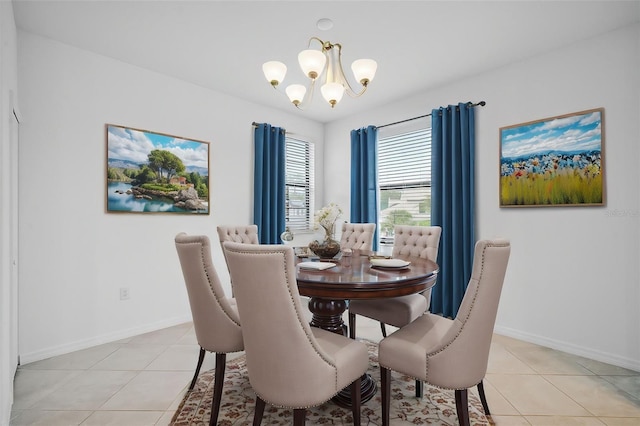 dining area featuring light tile patterned floors and an inviting chandelier