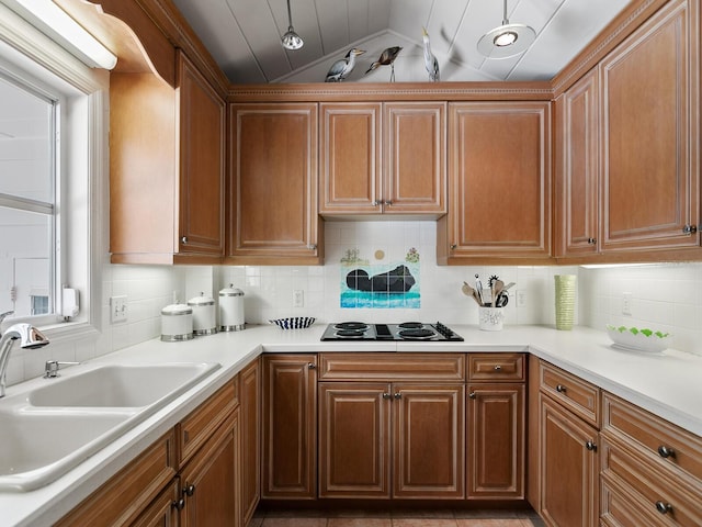 kitchen with decorative backsplash, white gas cooktop, lofted ceiling, and sink