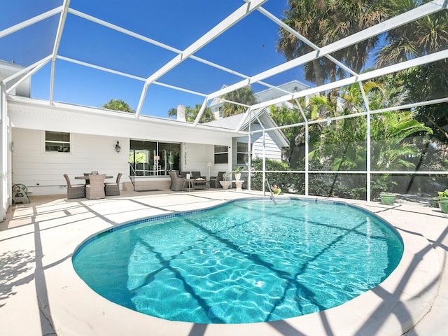 view of swimming pool with a patio, an outdoor living space, and glass enclosure