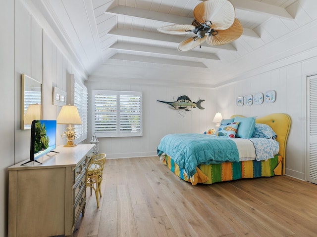 bedroom with ceiling fan, beam ceiling, and light hardwood / wood-style floors