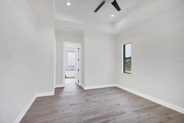 spare room with ceiling fan and hardwood / wood-style flooring