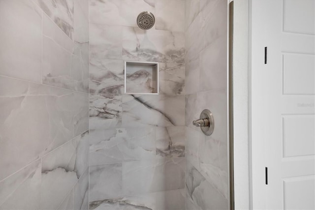 room details featuring a marble finish shower