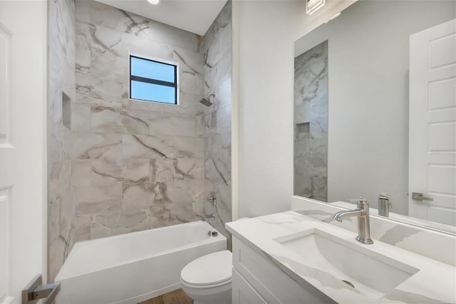 full bathroom with toilet, vanity, and tiled shower / bath