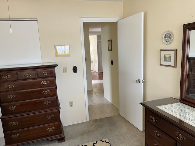 bedroom with light carpet and a closet