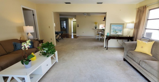 living room with light carpet and ceiling fan