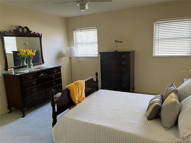 bedroom with ceiling fan and carpet flooring