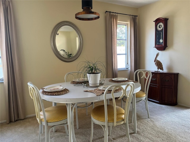 dining area featuring light colored carpet