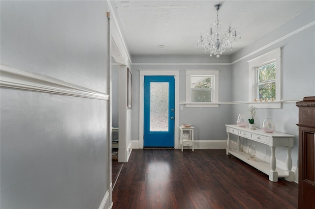 entrance foyer with dark hardwood / wood-style floors and a chandelier