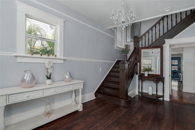 stairway with hardwood / wood-style flooring and a chandelier