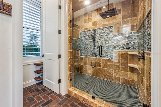 bathroom with a shower with door