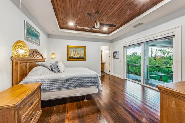 bedroom with ceiling fan, a tray ceiling, access to exterior, and dark hardwood / wood-style flooring