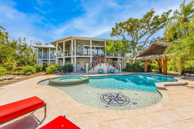 view of swimming pool featuring a gazebo, an in ground hot tub, and a patio area