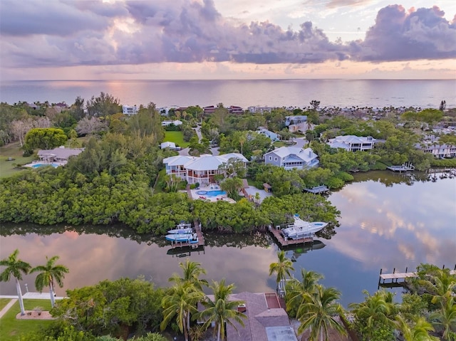 aerial view at dusk with a water view