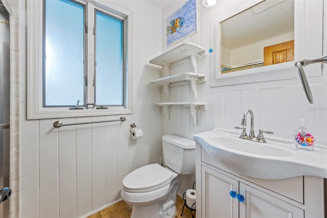 bathroom featuring toilet and vanity