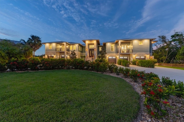 view of front of home with a balcony and a lawn