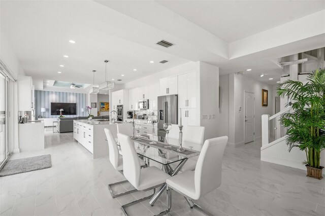 tiled dining area with ceiling fan