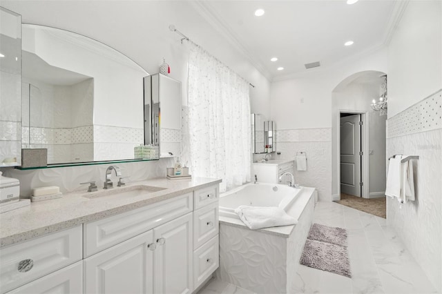 bathroom with vanity, tiled bath, crown molding, tile walls, and tile flooring