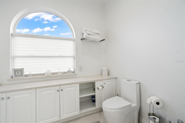 bathroom featuring toilet, vanity, and tile flooring