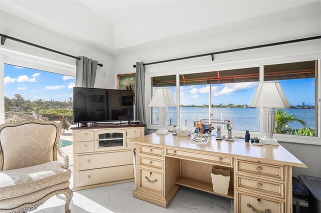 office featuring light tile floors and a water view