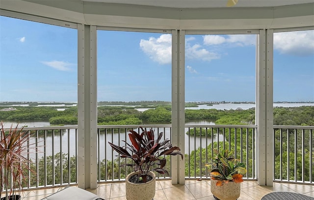 401 N Point Rd Unit 901, Osprey, FL 34229 - sunroom featuring a water view, tile patterned floors, and plenty of natural light