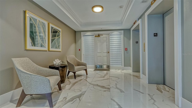 living area with ornamental molding, elevator, and a tray ceiling