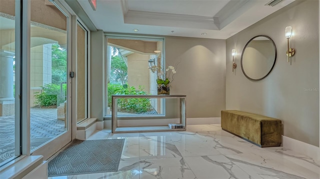 entryway featuring crown molding and a raised ceiling