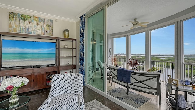 401 N Point Rd Unit 901, Osprey, FL 34229 - sunroom / solarium with ornamental molding, wood finished floors, and a water view