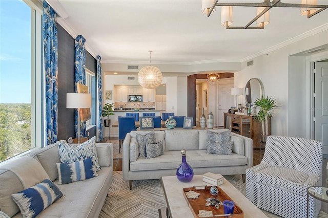 401 N Point Rd Unit 901, Osprey, FL 34229 - living area with a chandelier and ornamental molding
