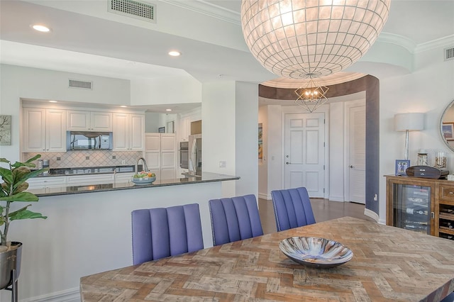 dining room with parquet flooring and ornamental molding