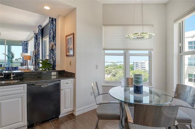 401 N Point Rd Unit 901, Osprey, FL 34229 - kitchen featuring dishwasher, white cabinetry, a chandelier, baseboards, and dark stone countertops