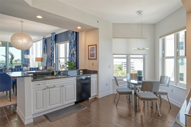 kitchen with white cabinets, hanging light fixtures, dishwasher, dark wood-type flooring, and sink