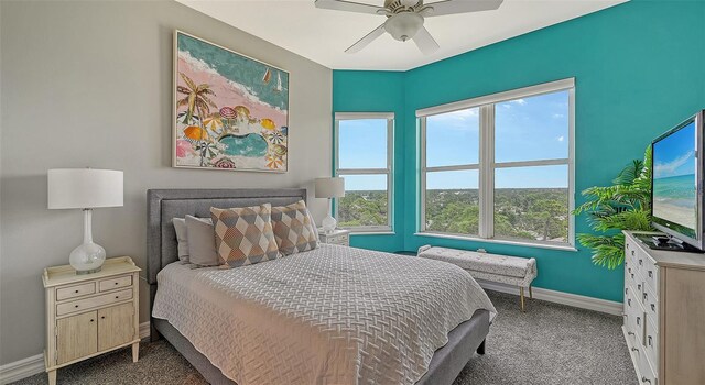 401 N Point Rd Unit 901, Osprey, FL 34229 - bedroom with carpet floors, multiple windows, baseboards, and ceiling fan