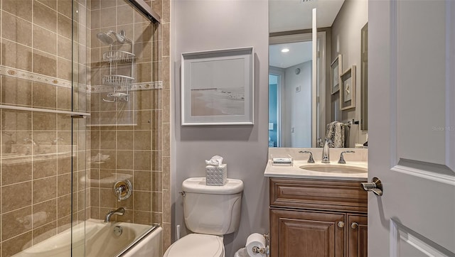 full bathroom featuring vanity, toilet, and bath / shower combo with glass door