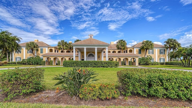 401 N Point Rd Unit 901, Osprey, FL 34229 - mediterranean / spanish-style house featuring stucco siding, a front yard, and a chimney
